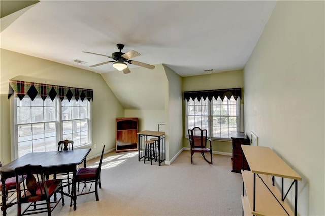 dining space with visible vents, lofted ceiling, carpet, and ceiling fan