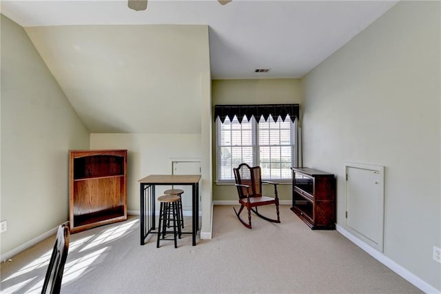 carpeted office space featuring visible vents, baseboards, and lofted ceiling