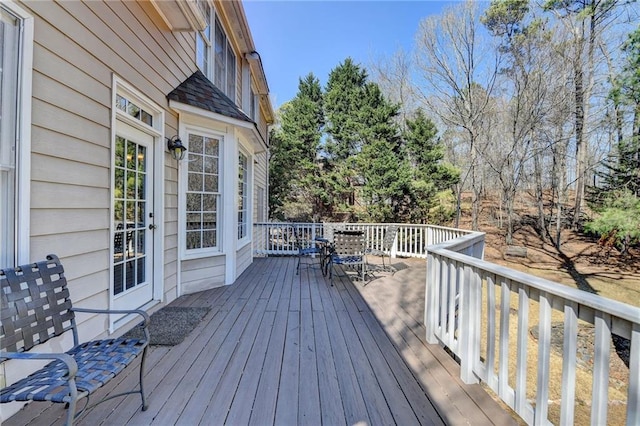 wooden deck featuring outdoor dining area