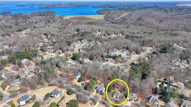 bird's eye view featuring a view of trees and a water view