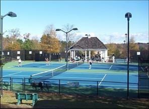 view of tennis court featuring fence