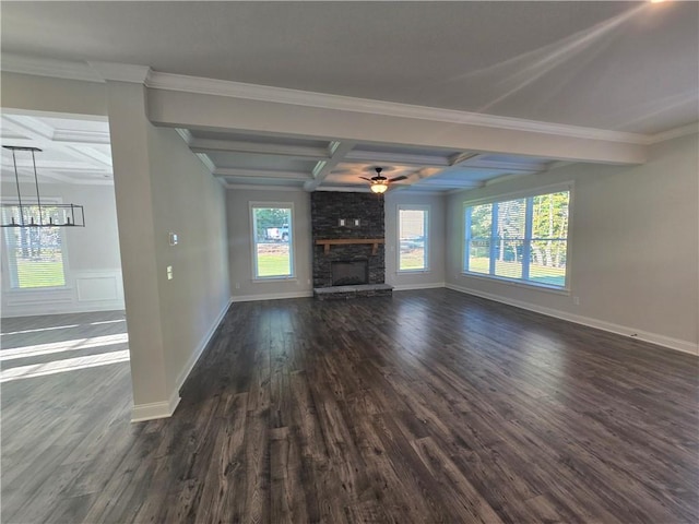 unfurnished living room featuring dark wood-type flooring, coffered ceiling, a stone fireplace, crown molding, and beam ceiling