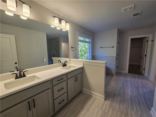 bathroom featuring a shower and vanity