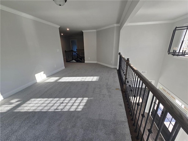 empty room with carpet flooring, a notable chandelier, and crown molding