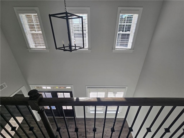 staircase featuring an inviting chandelier