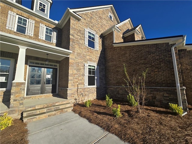 view of exterior entry featuring french doors