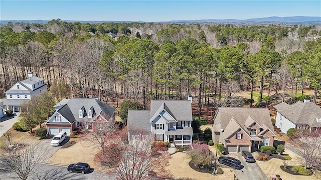 birds eye view of property featuring a forest view and a residential view