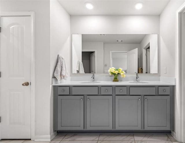 309 Vista Ln, Woodstock, GA 30189 - bathroom featuring double vanity, visible vents, marble finish floor, and a sink