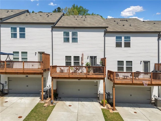 309 Vista Ln, Woodstock, GA 30189 - back of property featuring a shingled roof, driveway, and an attached garage