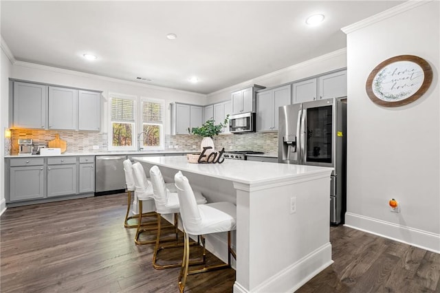 309 Vista Ln, Woodstock, GA 30189 - kitchen with a kitchen island, gray cabinets, ornamental molding, and appliances with stainless steel finishes