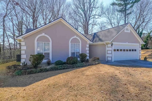 ranch-style house featuring roof with shingles, stucco siding, concrete driveway, an attached garage, and fence