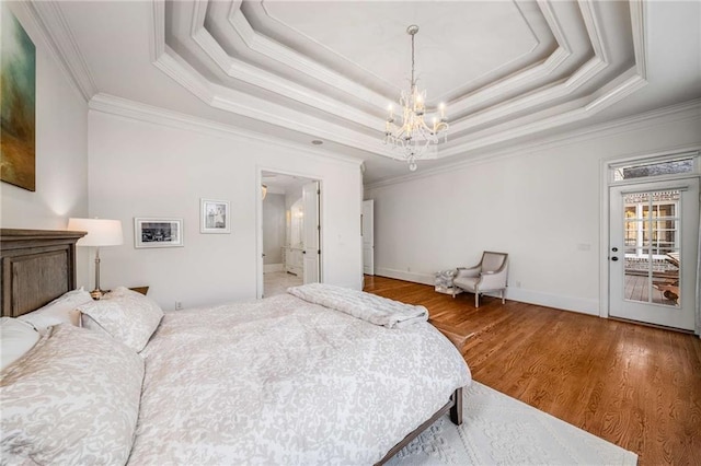 bedroom featuring a chandelier, ornamental molding, and a tray ceiling