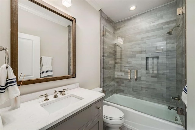 full bathroom with vanity, toilet, and enclosed tub / shower combo