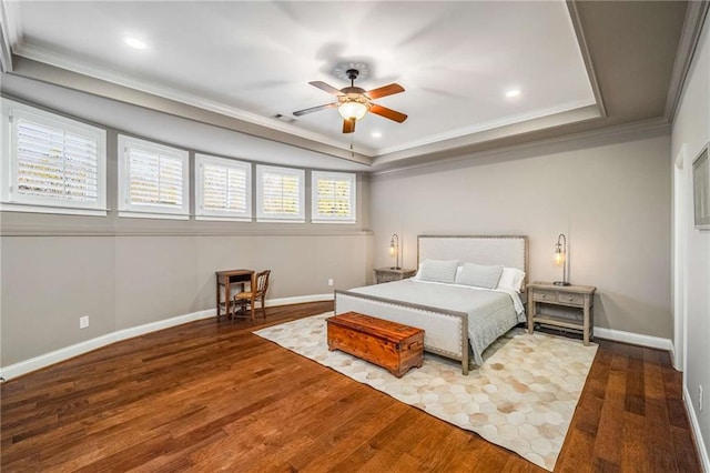 bedroom featuring hardwood / wood-style floors, a raised ceiling, ceiling fan, and ornamental molding