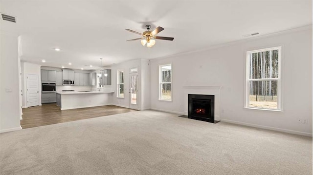13567 Whitman Ln, Covington, GA 30014 - unfurnished living room with light carpet, recessed lighting, a fireplace with flush hearth, baseboards, and a ceiling fan