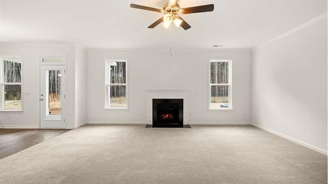 13567 Whitman Ln, Covington, GA 30014 - unfurnished living room with carpet floors, crown molding, a fireplace with flush hearth, baseboards, and ceiling fan