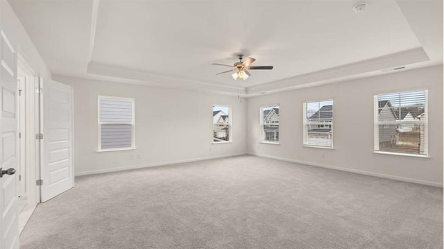 13567 Whitman Ln, Covington, GA 30014 - unfurnished room featuring a tray ceiling, light carpet, a ceiling fan, and baseboards