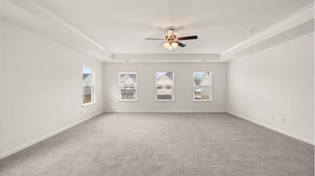 13567 Whitman Ln, Covington, GA 30014 - empty room with a tray ceiling, carpet floors, ceiling fan, and baseboards