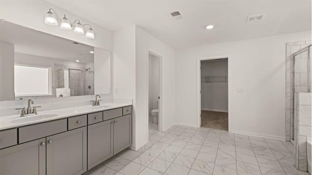 13567 Whitman Ln, Covington, GA 30014 - bathroom with a shower stall, double vanity, marble finish floors, toilet, and baseboards