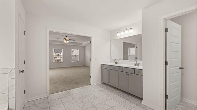 13567 Whitman Ln, Covington, GA 30014 - bathroom with double vanity, a ceiling fan, baseboards, and marble finish floors