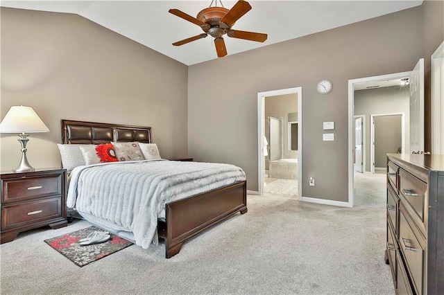 bedroom with light carpet, baseboards, a ceiling fan, ensuite bathroom, and vaulted ceiling