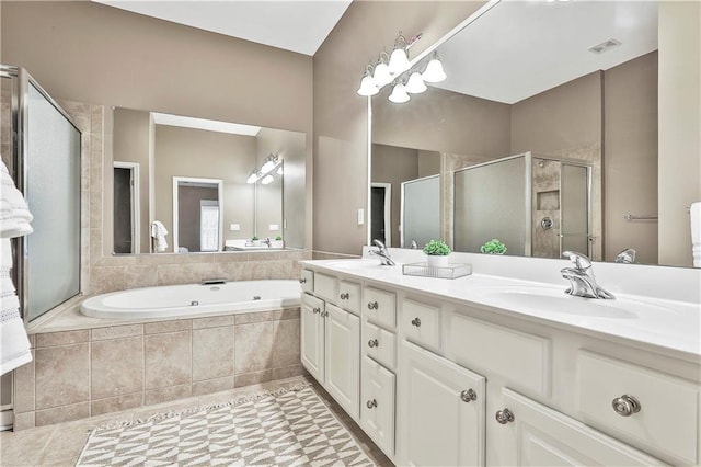 bathroom with a garden tub, a stall shower, a sink, and visible vents