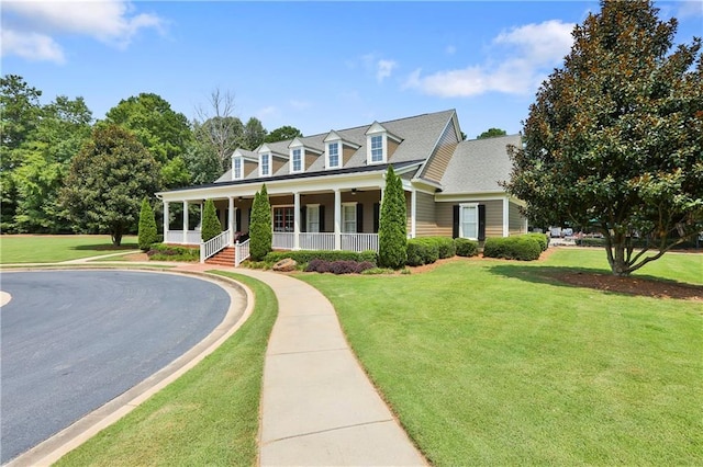 cape cod house featuring a front yard and covered porch