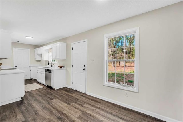 254 Barnesville Rd, Milner, GA 30257 - kitchen featuring dark wood finished floors, stainless steel dishwasher, baseboards, and light countertops