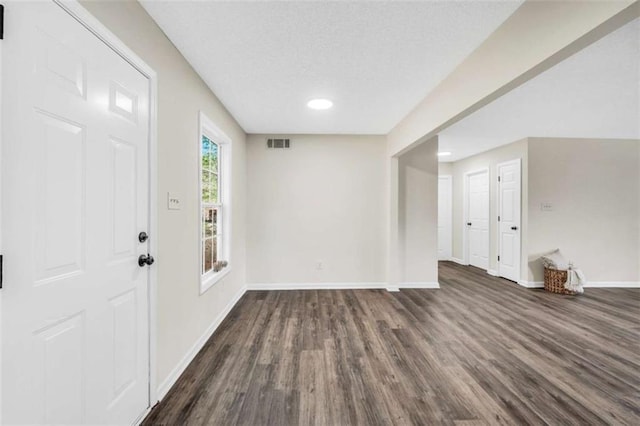 254 Barnesville Rd, Milner, GA 30257 - foyer entrance with dark wood finished floors, baseboards, visible vents, and recessed lighting