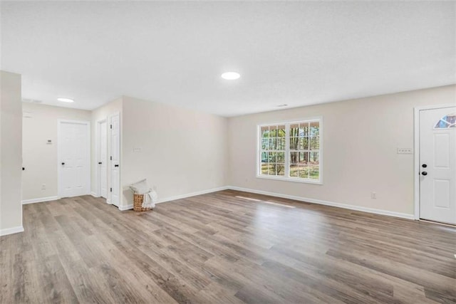 254 Barnesville Rd, Milner, GA 30257 - unfurnished living room with baseboards, wood finished floors, and recessed lighting