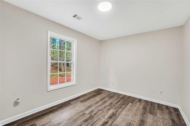 254 Barnesville Rd, Milner, GA 30257 - unfurnished room with baseboards, wood finished floors, and visible vents