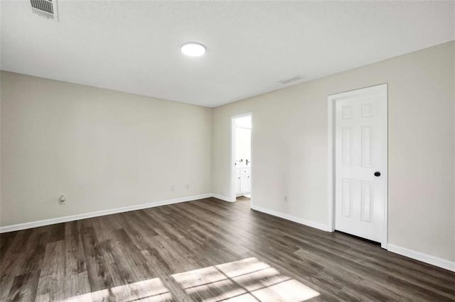 254 Barnesville Rd, Milner, GA 30257 - empty room with visible vents, baseboards, and dark wood-style flooring