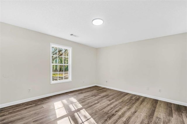 254 Barnesville Rd, Milner, GA 30257 - unfurnished room featuring visible vents, baseboards, and wood finished floors