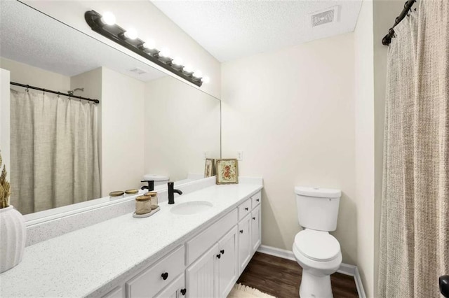 254 Barnesville Rd, Milner, GA 30257 - bathroom with a textured ceiling, toilet, visible vents, wood finished floors, and vanity