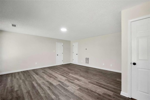 254 Barnesville Rd, Milner, GA 30257 - spare room featuring dark wood finished floors, baseboards, visible vents, and a textured ceiling