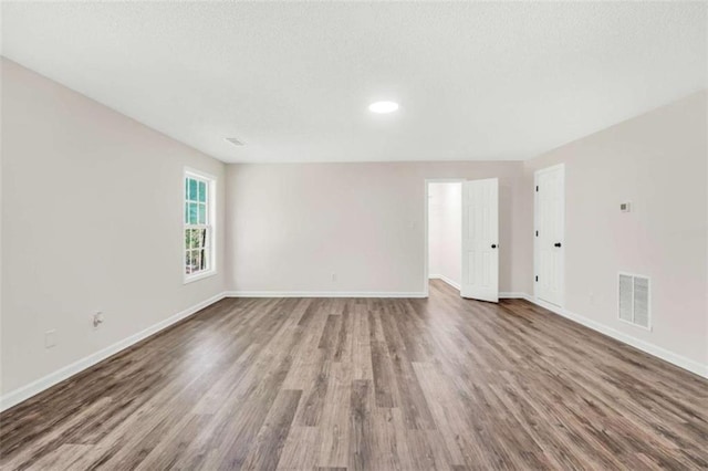 254 Barnesville Rd, Milner, GA 30257 - unfurnished room with baseboards, wood finished floors, and visible vents