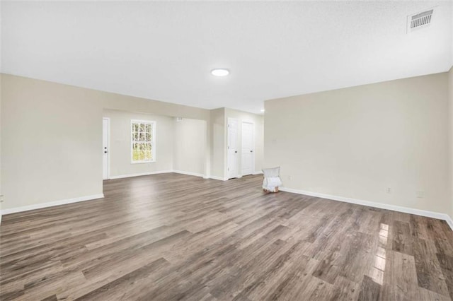 254 Barnesville Rd, Milner, GA 30257 - unfurnished living room featuring baseboards, wood finished floors, and visible vents