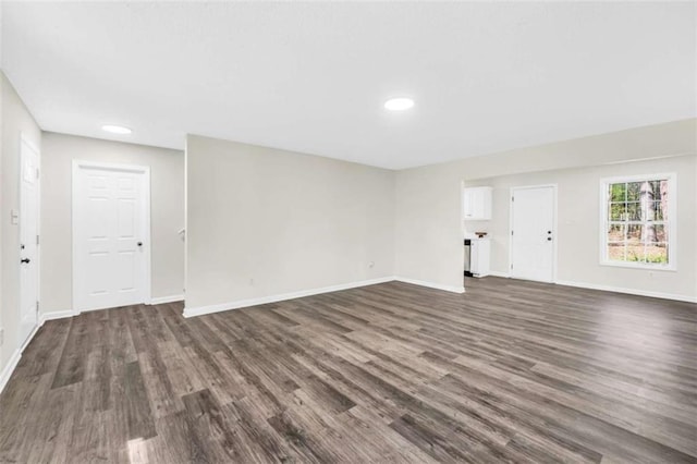 254 Barnesville Rd, Milner, GA 30257 - unfurnished living room featuring baseboards, recessed lighting, and dark wood finished floors