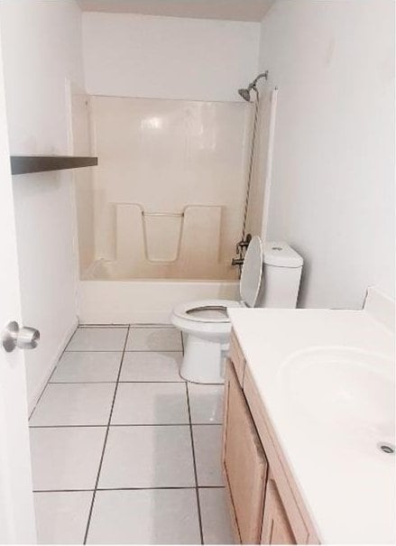 full bathroom featuring tile patterned flooring, vanity, toilet, and tub / shower combination