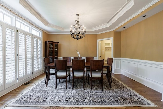 4310 Granby Way, Marietta, GA 30062 - dining area with a chandelier, a raised ceiling, crown molding, wood finished floors, and wainscoting