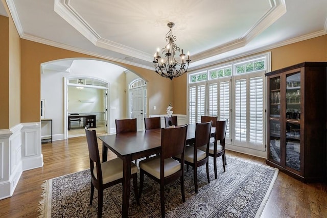 4310 Granby Way, Marietta, GA 30062 - dining room with arched walkways, a tray ceiling, a chandelier, ornamental molding, and wood finished floors