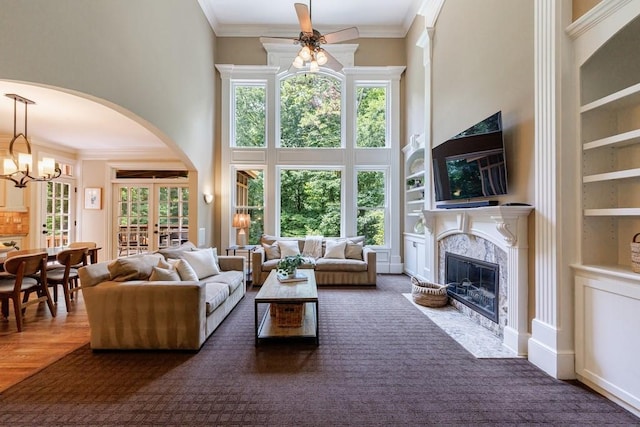 4310 Granby Way, Marietta, GA 30062 - living area with a towering ceiling, a premium fireplace, a ceiling fan, arched walkways, and built in features