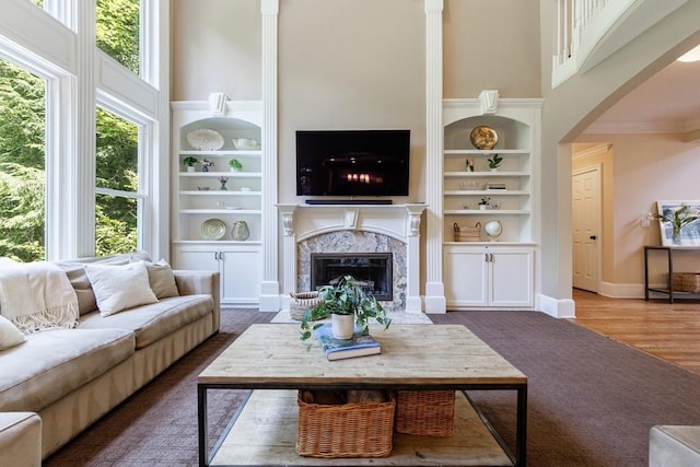 4310 Granby Way, Marietta, GA 30062 - living area with a towering ceiling, arched walkways, built in shelves, a fireplace, and crown molding