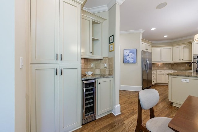 4310 Granby Way, Marietta, GA 30062 - indoor bar featuring beverage cooler, stainless steel refrigerator with ice dispenser, decorative backsplash, dark wood finished floors, and crown molding
