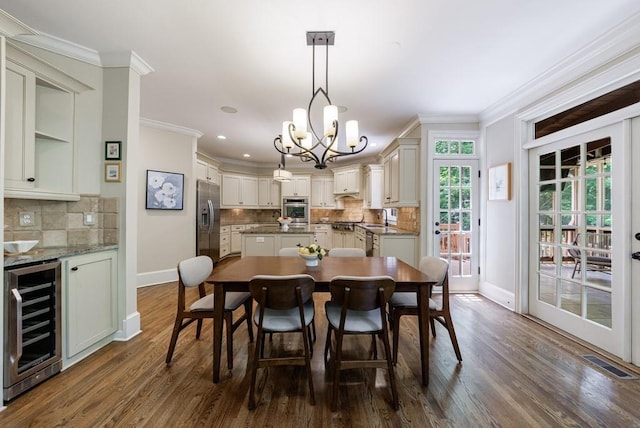 4310 Granby Way, Marietta, GA 30062 - dining space featuring beverage cooler, crown molding, dark wood-type flooring, a chandelier, and recessed lighting