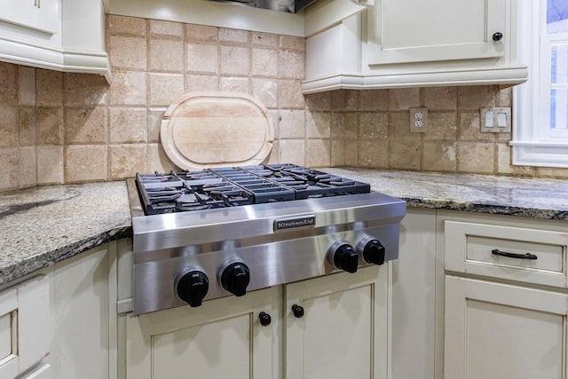 4310 Granby Way, Marietta, GA 30062 - kitchen with stainless steel gas stovetop, tasteful backsplash, light stone countertops, and white cabinets