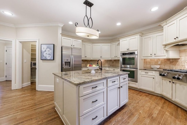4310 Granby Way, Marietta, GA 30062 - kitchen with appliances with stainless steel finishes, crown molding, white cabinets, pendant lighting, and backsplash
