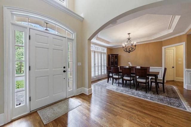 4310 Granby Way, Marietta, GA 30062 - foyer featuring arched walkways, a chandelier, wood finished floors, ornamental molding, and a raised ceiling