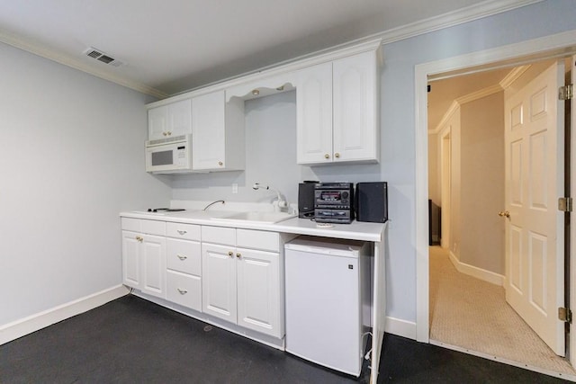 4310 Granby Way, Marietta, GA 30062 - kitchen with white microwave, white cabinetry, light countertops, and ornamental molding