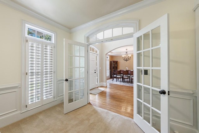 4310 Granby Way, Marietta, GA 30062 - foyer entrance featuring french doors, a chandelier, crown molding, light carpet, and arched walkways